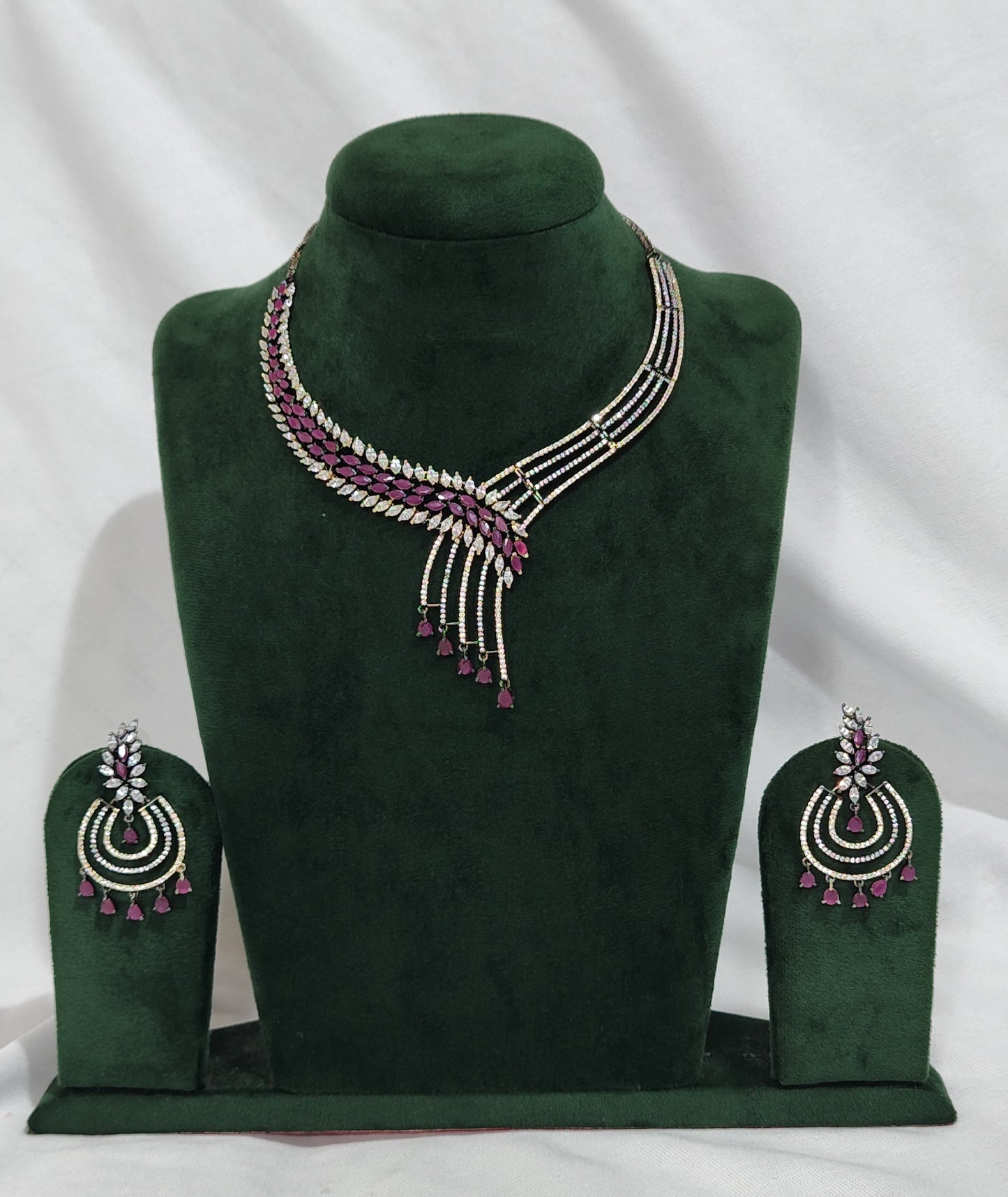American Diamond necklace set with asymmetrical design, ruby drop beads, and matching earrings – festive jewellery
