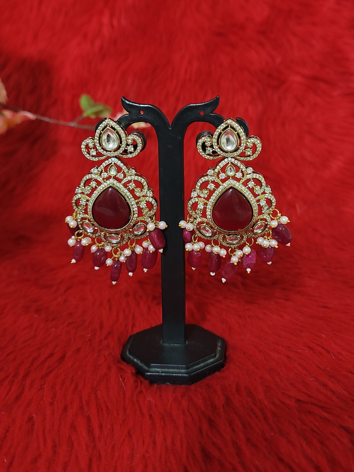 Bridal Kundan earrings with red stone drops on stand