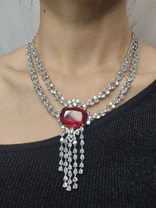 Double-layer American Diamond necklace set with red stone pendant and matching earrings in silver finish