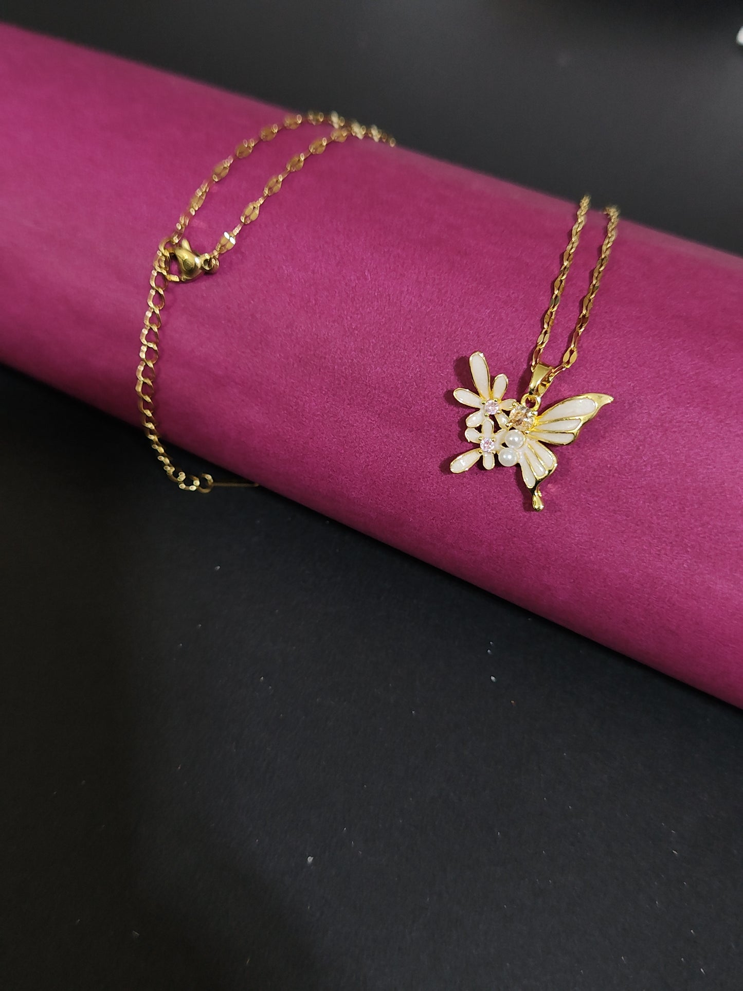 Anti-tarnish butterfly charm necklace with pearl and stone details.