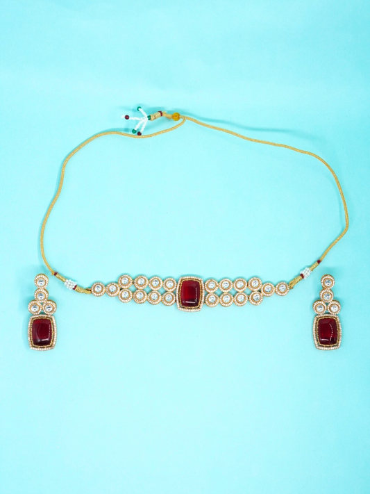 Moissanite choker necklace with ruby red stone and matching earrings on blue background