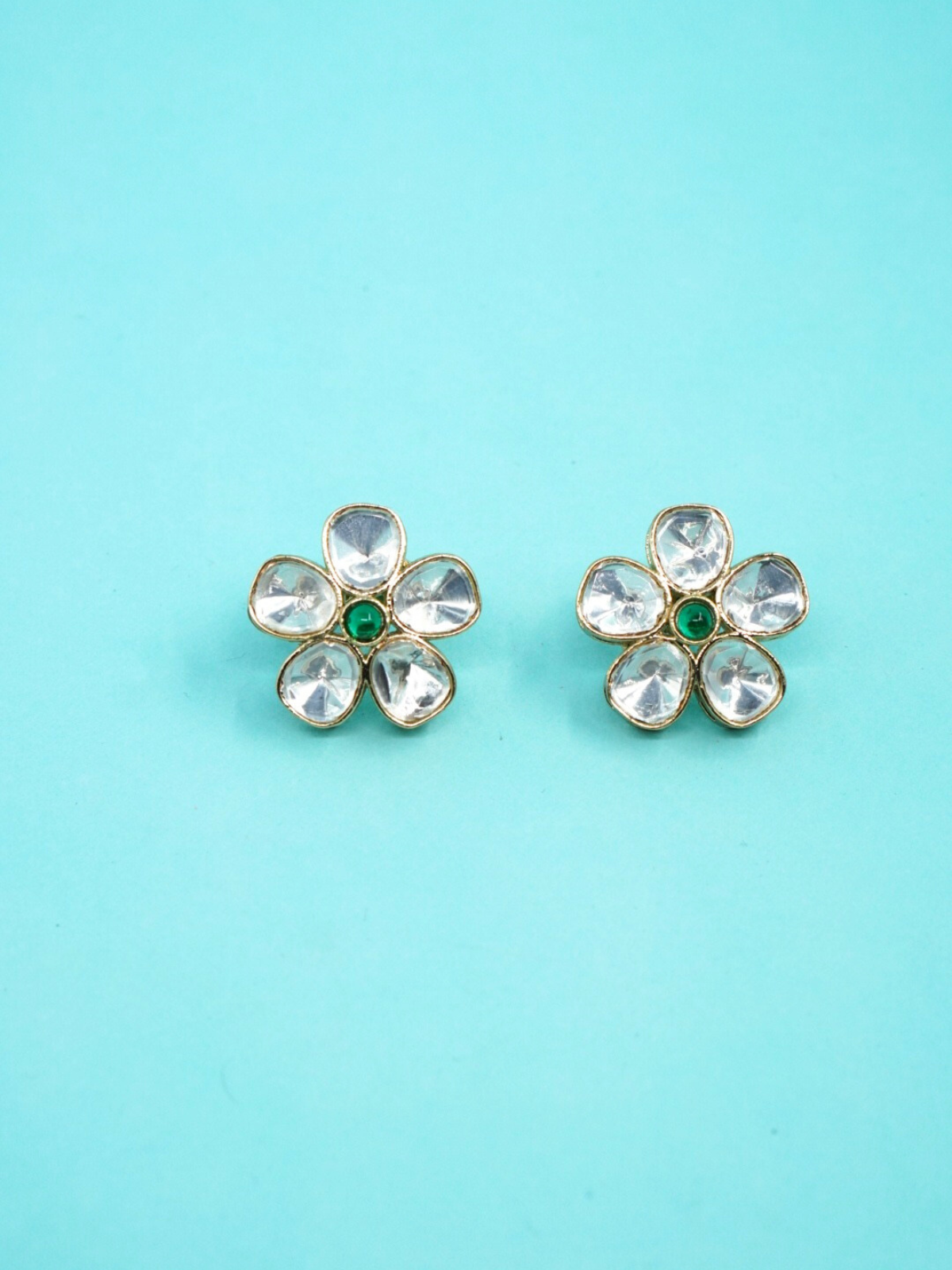 Moissanite floral earrings on blue background
