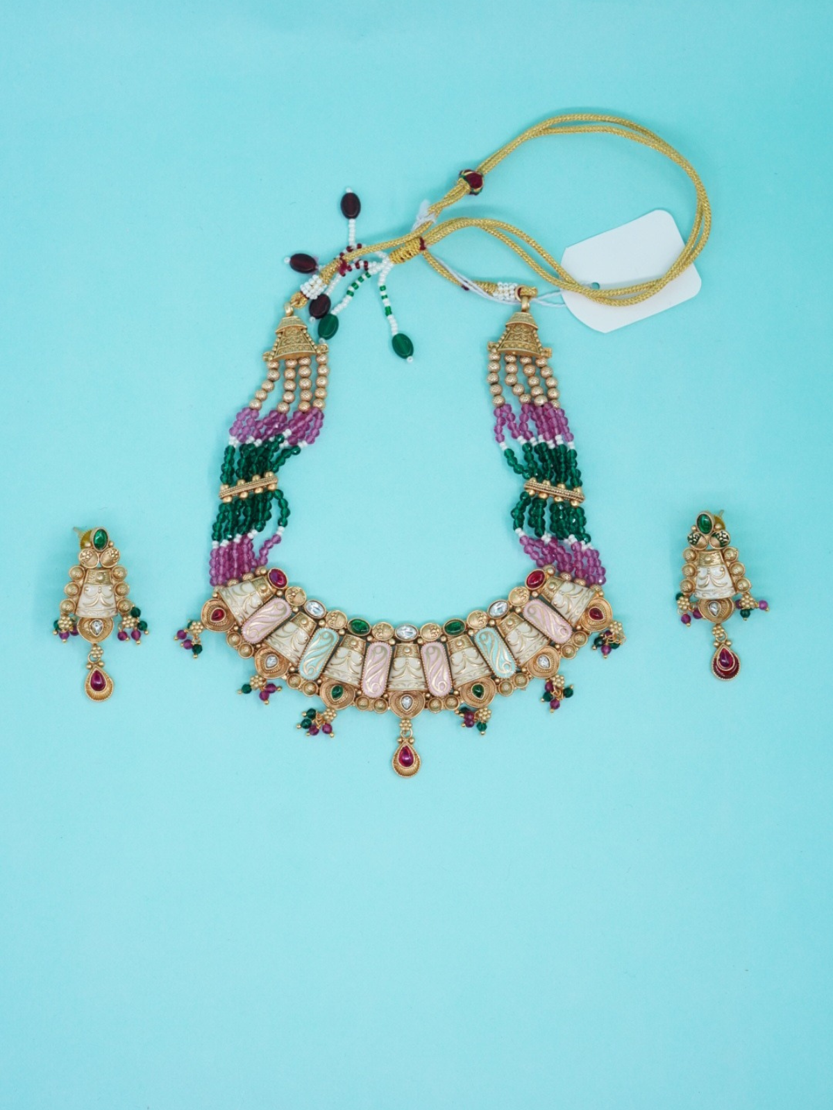 Multicolour beaded choker necklace set with carved panels and matching earrings top view