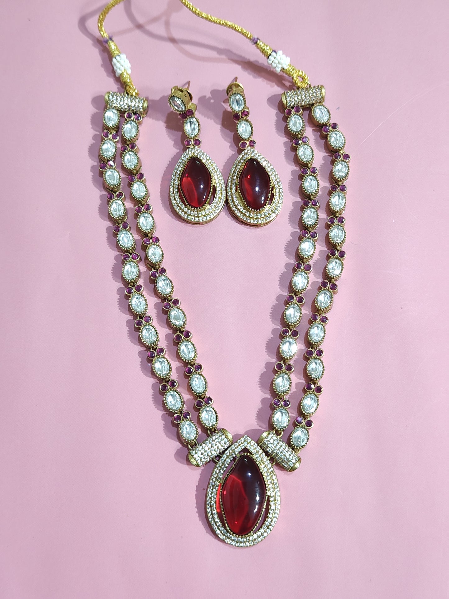 Premium kundan necklace set with twin-layer chain, maroon masonite pendant, and matching earrings displayed close-up