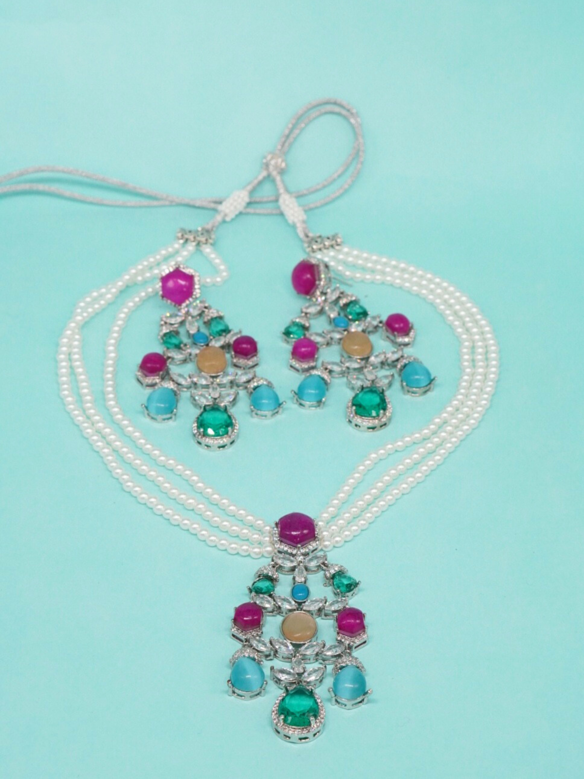 Sabyasachi-inspired pearl necklace set with multi-colored stone pendant and matching earrings