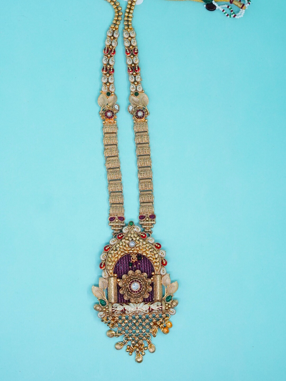Temple-style long haram necklace set with antique pendant top view