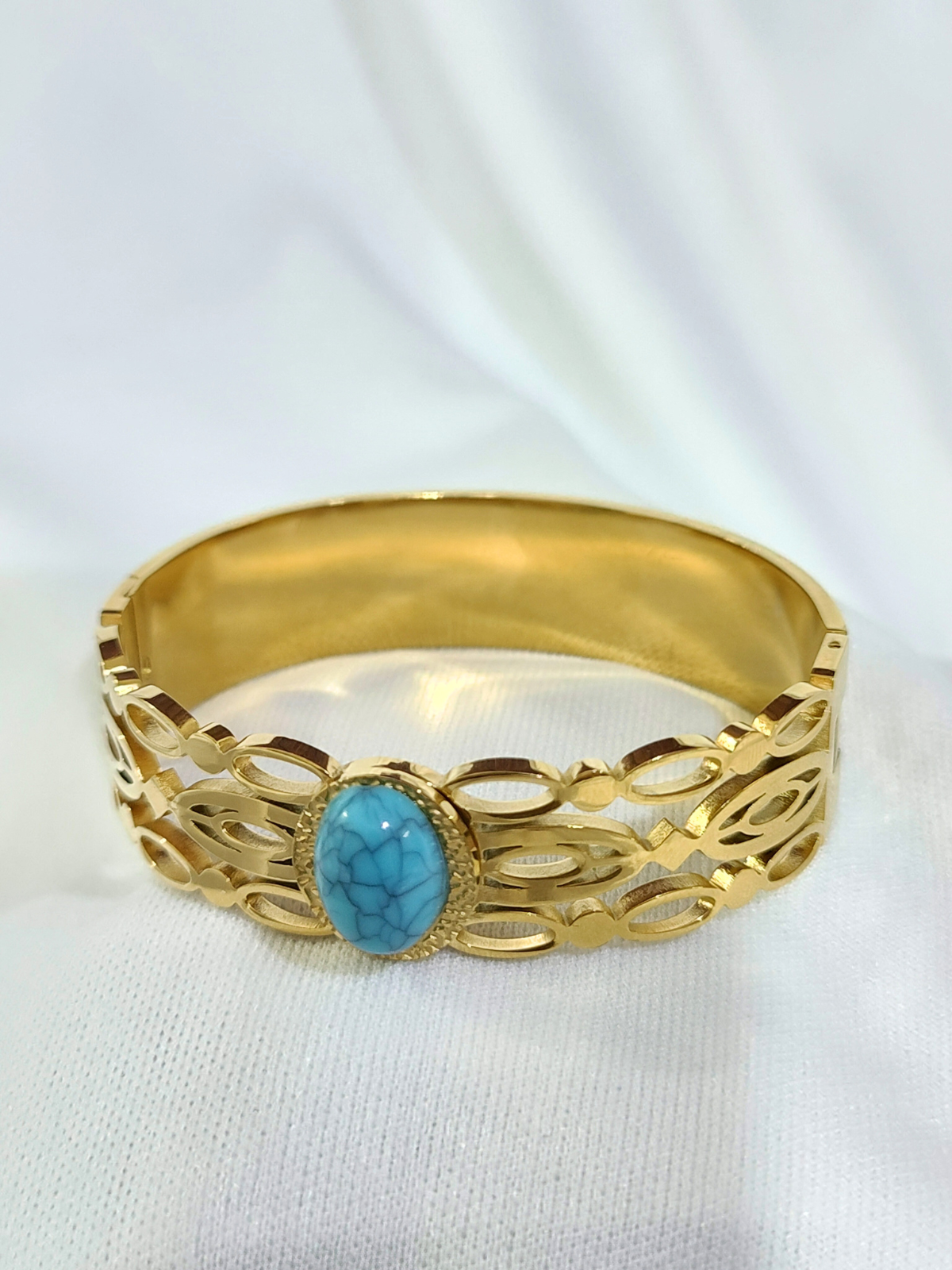 Turquoise stone wide gold finish bracelet with open cut design