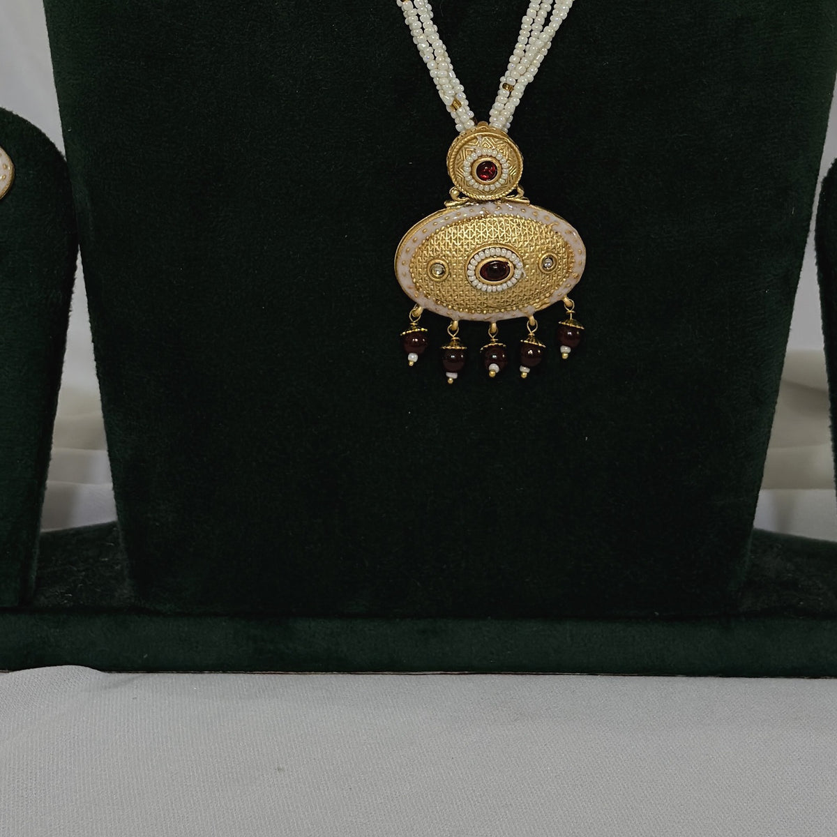 Close-up of copper-finish pendant and matching earrings