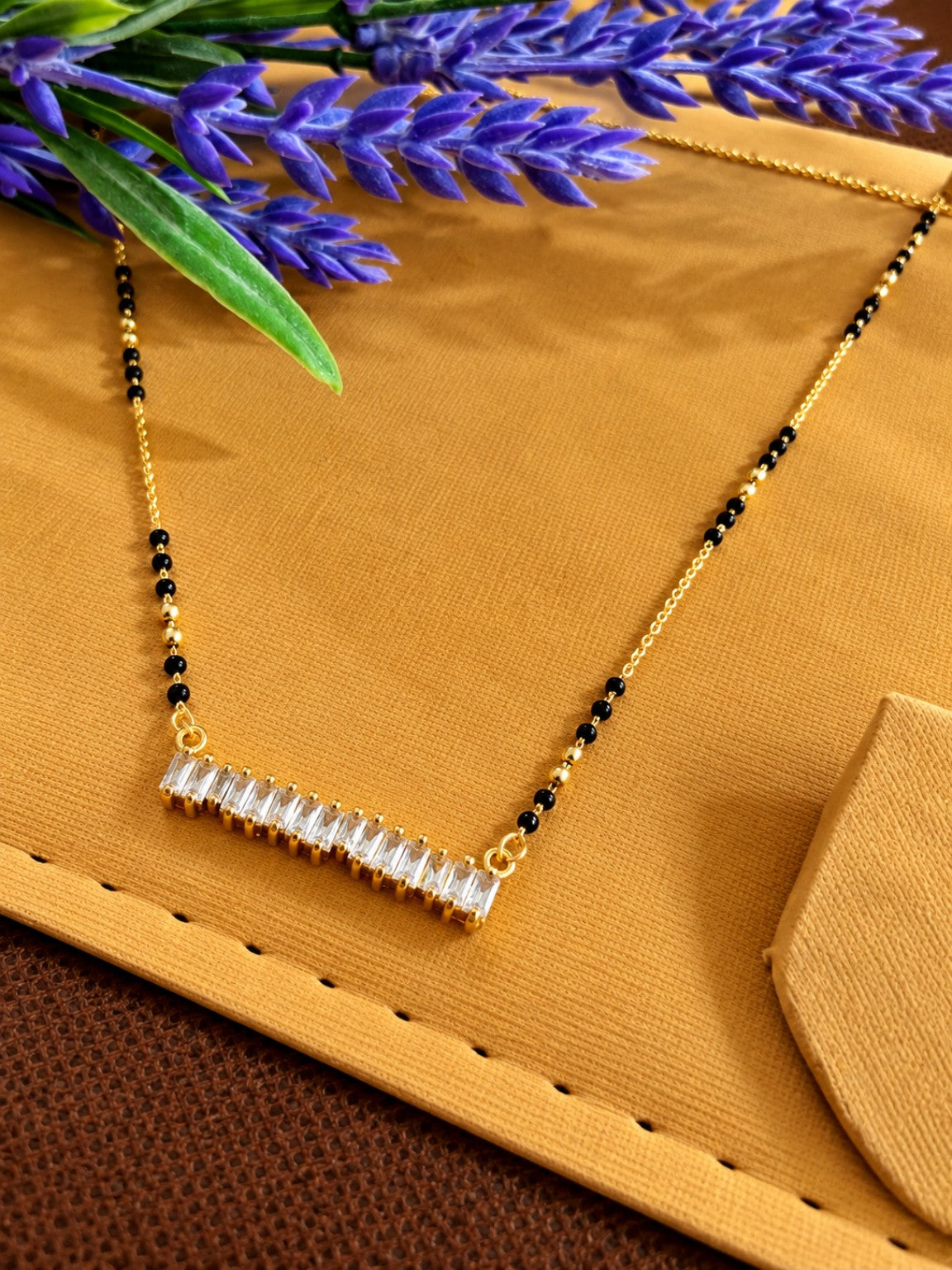 Micro gold-plated black bead mangalsutra with horizontal baguette stone bar pendant