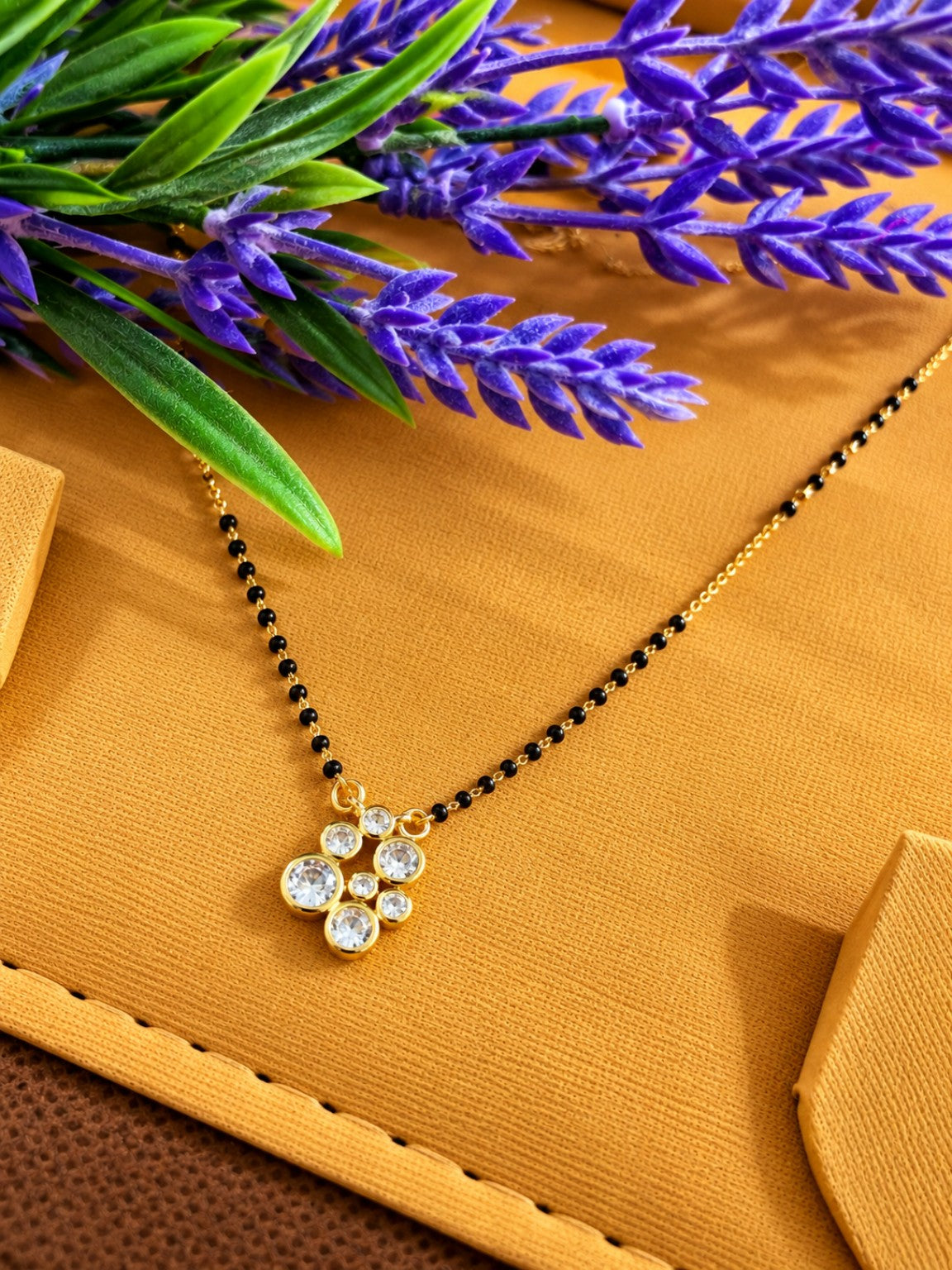 Micro gold-plated black bead mangalsutra with clustered round clear stone pendant