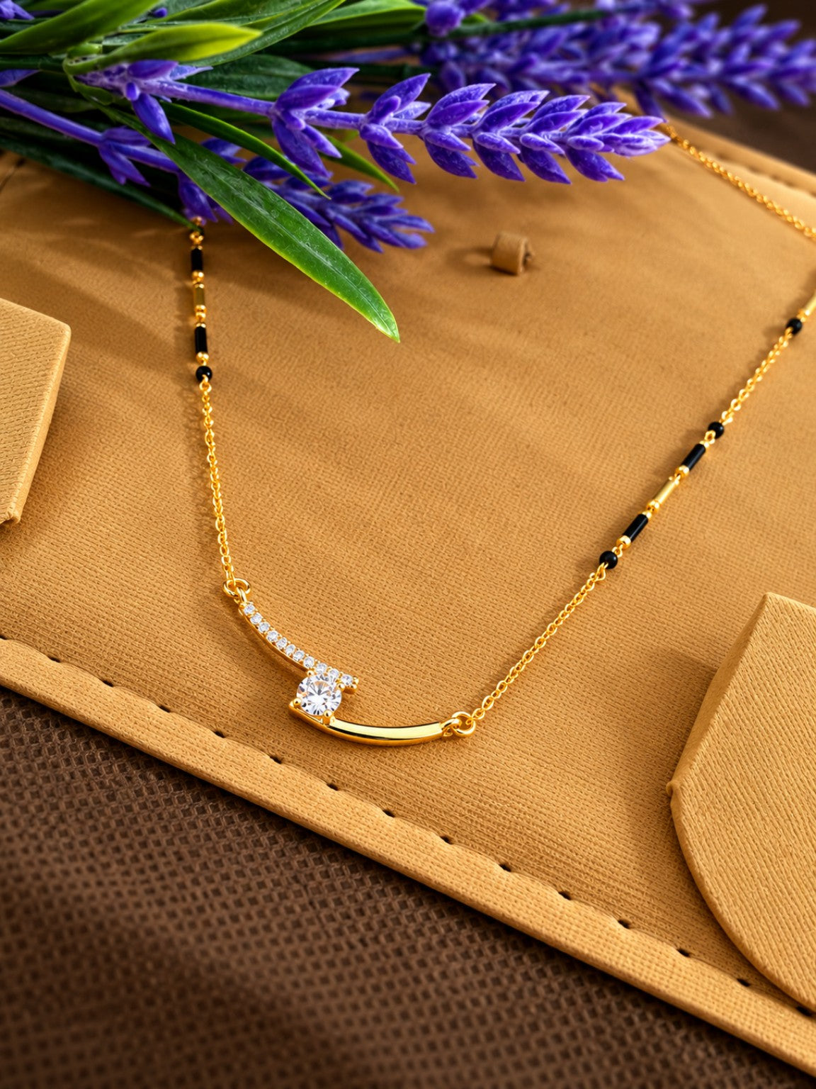 Micro gold-plated black bead mangalsutra with curved stone bar and round solitaire-style centre pendant