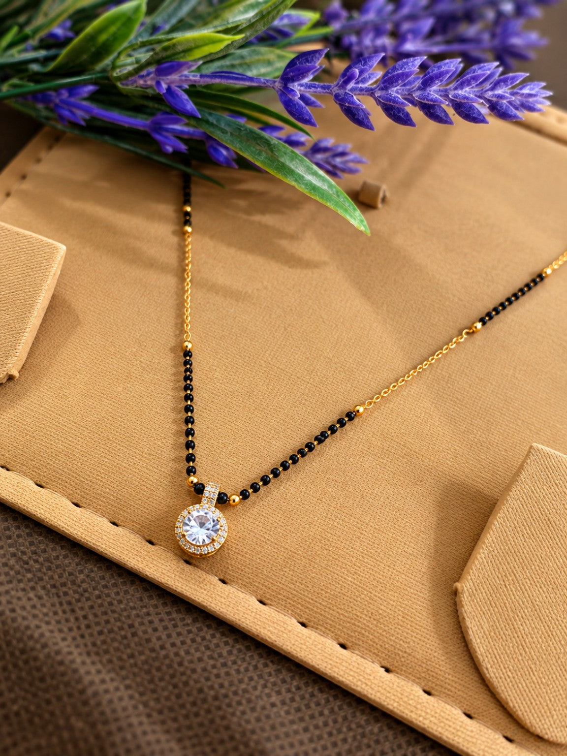 Black bead mangalsutra necklace with round stone pendant and stone-studded circular border