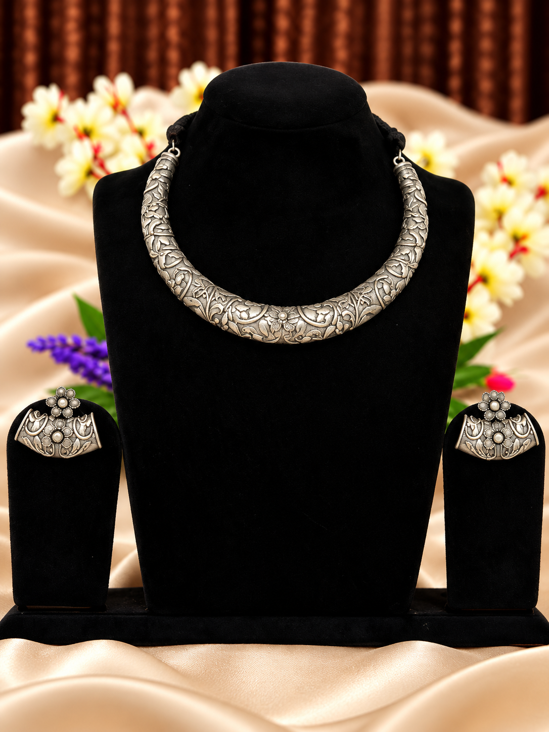 Oxidised silver replica engraved hasli necklace set with floral detailing and matching earrings