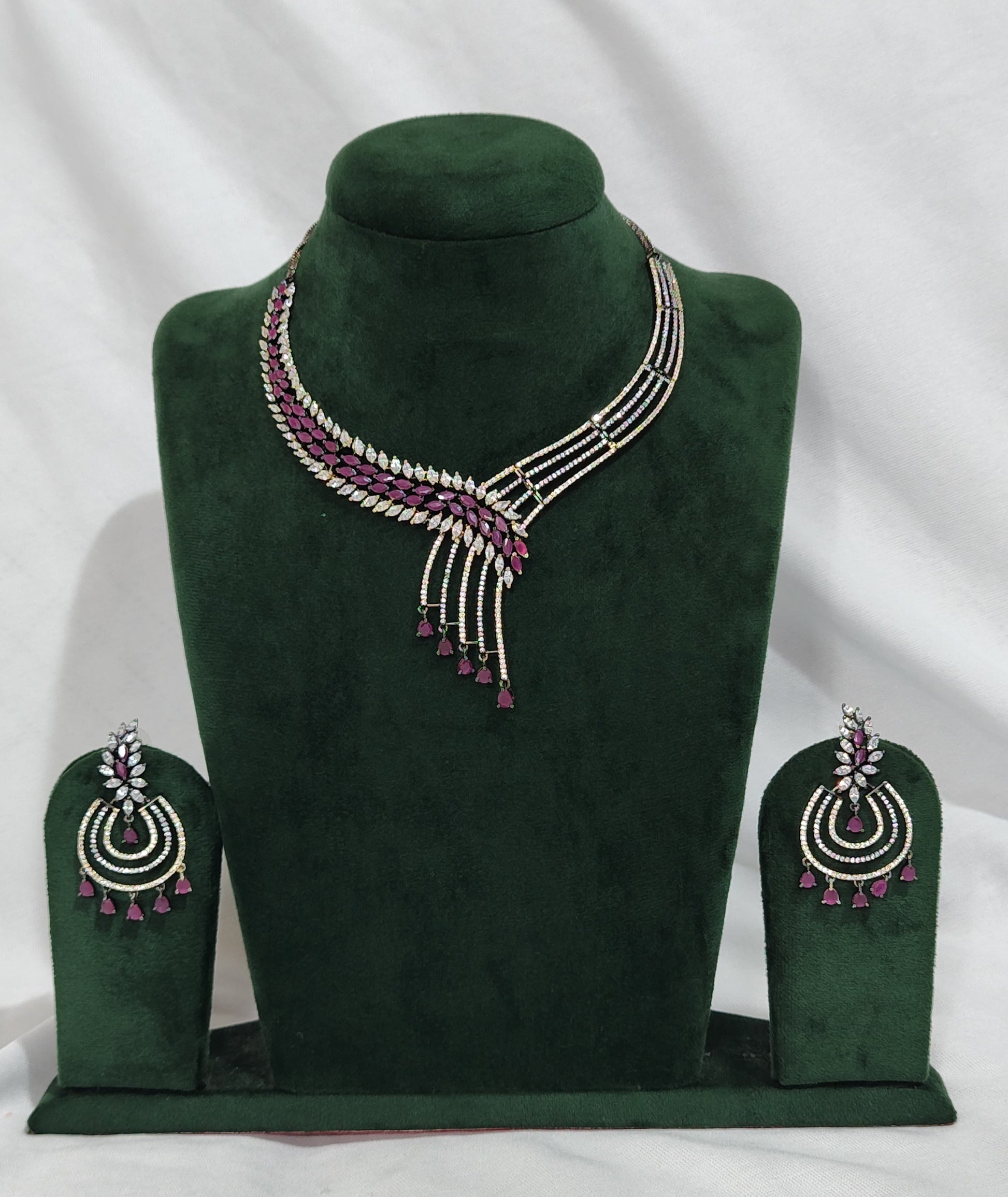 American Diamond necklace set with asymmetrical design, ruby drop beads, and matching earrings – festive jewellery