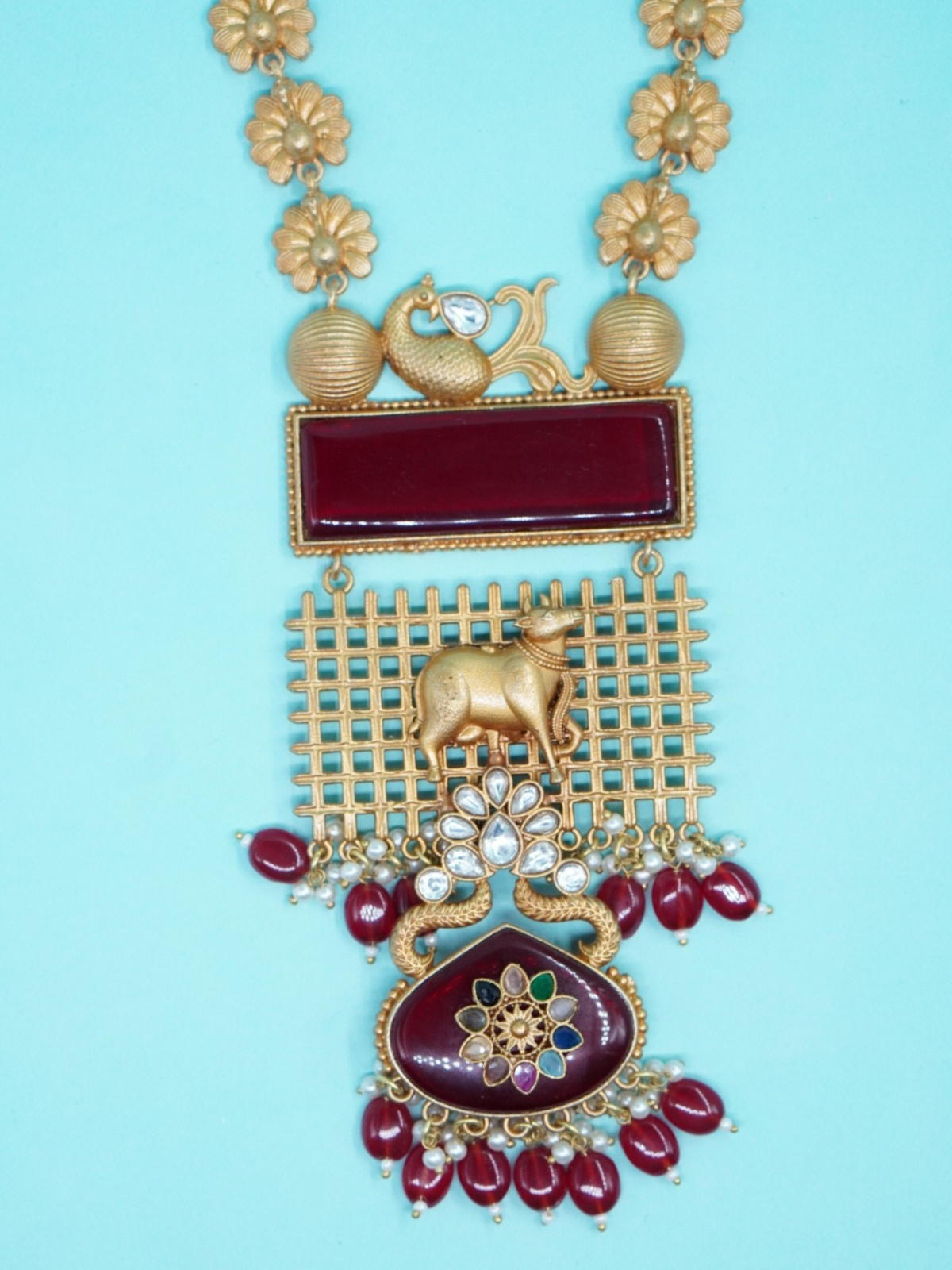Apala Long State red stone temple necklace set with cow motif  on blue background