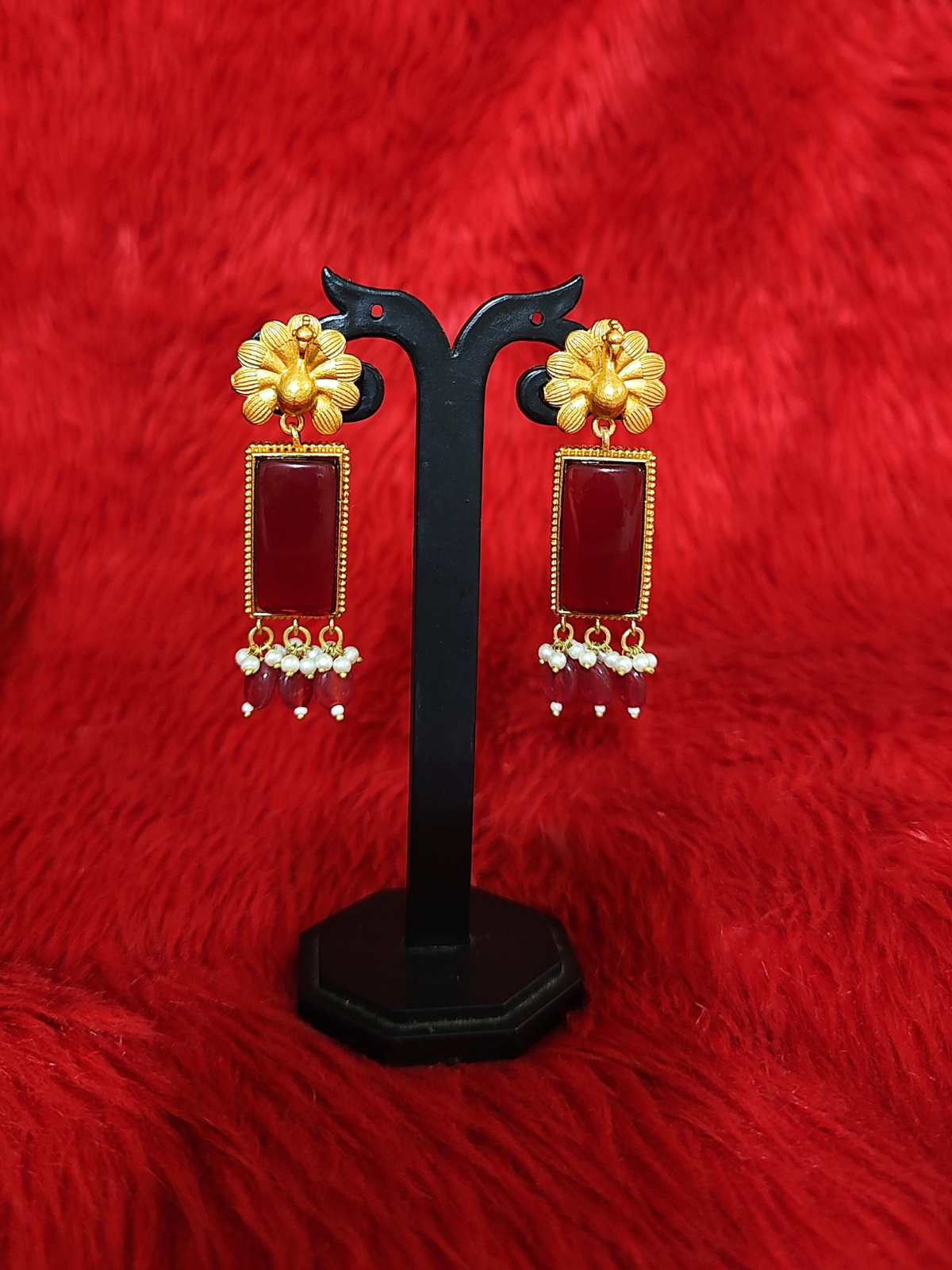 Apala red stone temple earrings on stand