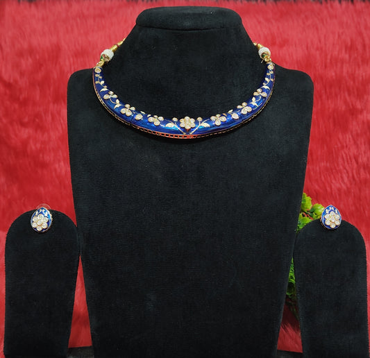 Blue meenakari necklace set with kundan floral designs and matching stud earrings displayed on black stand