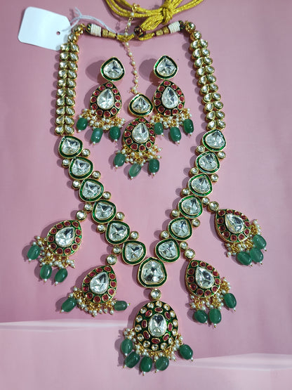 Double-layer bridal kundan necklace set with red and green stones, earrings and maang tikka 