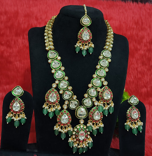 Double-layer bridal kundan necklace set with red and green stones, earrings and maang tikka