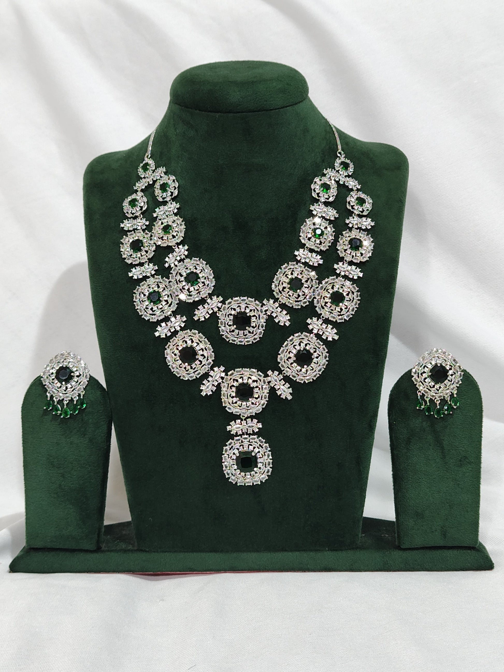 Grand American Diamond bridal necklace set with circular design and emerald green accents – matching earrings included