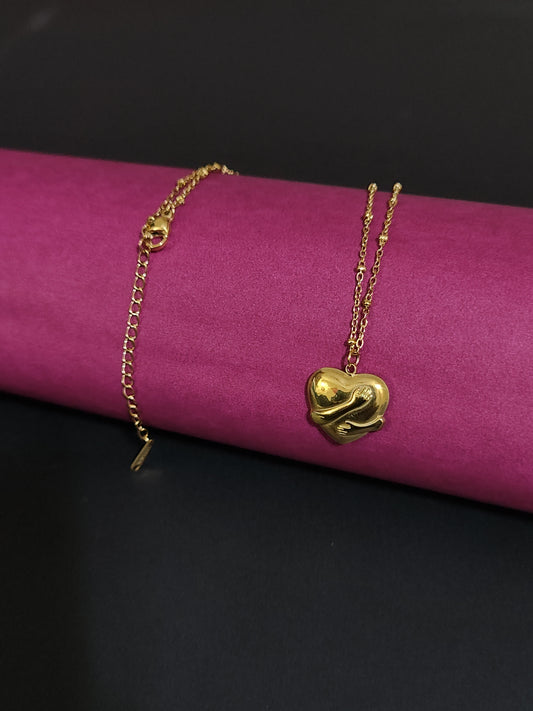 Anti-tarnish heart charm necklace with embracing hands design.