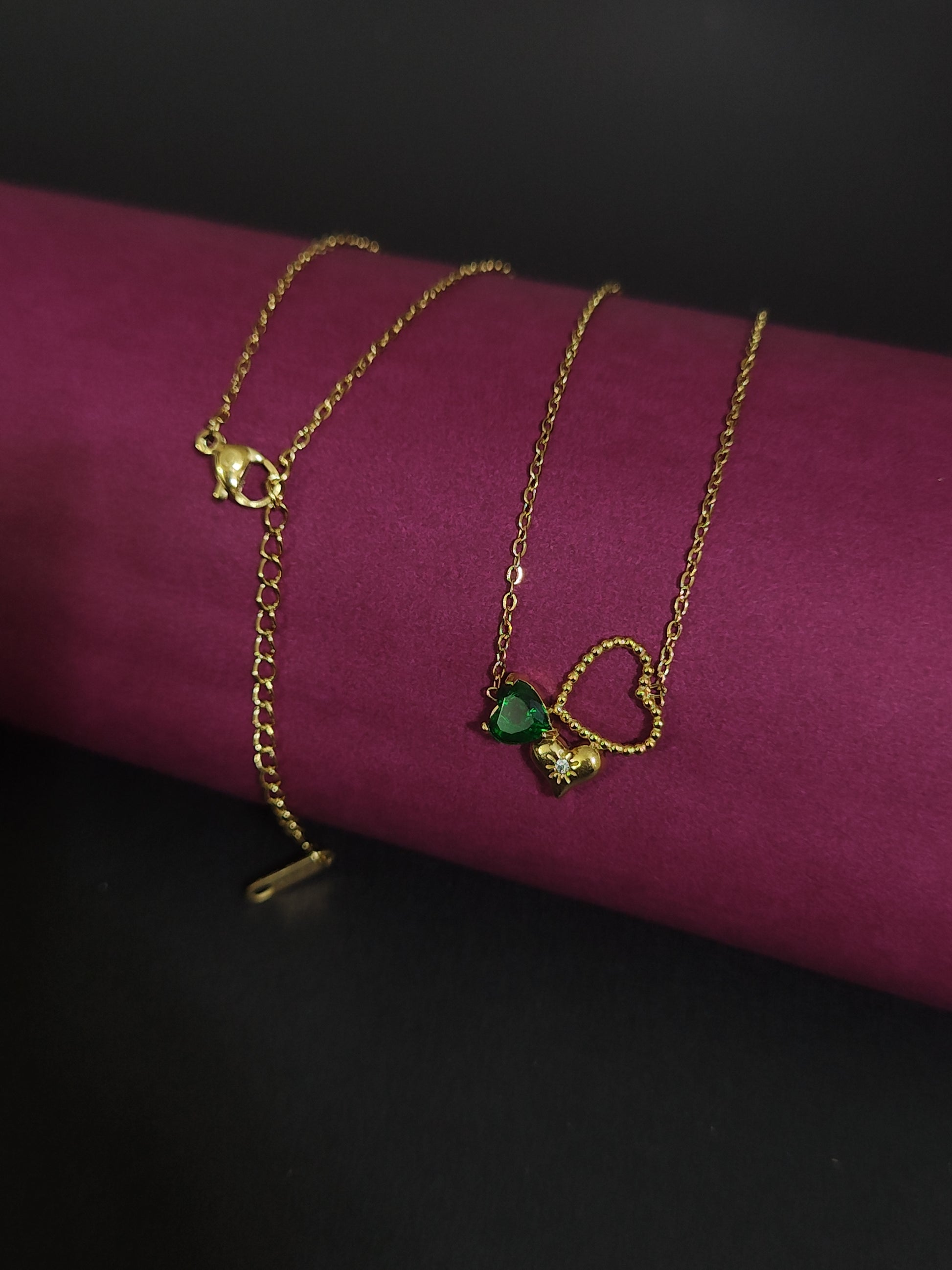 Anti-tarnish heart charm necklace with green stone and floral detail