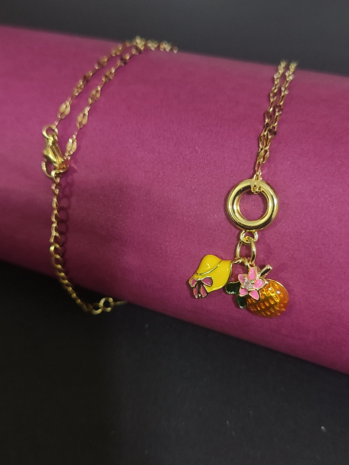 Anti-tarnish fruit and bow charm necklace with cute details.