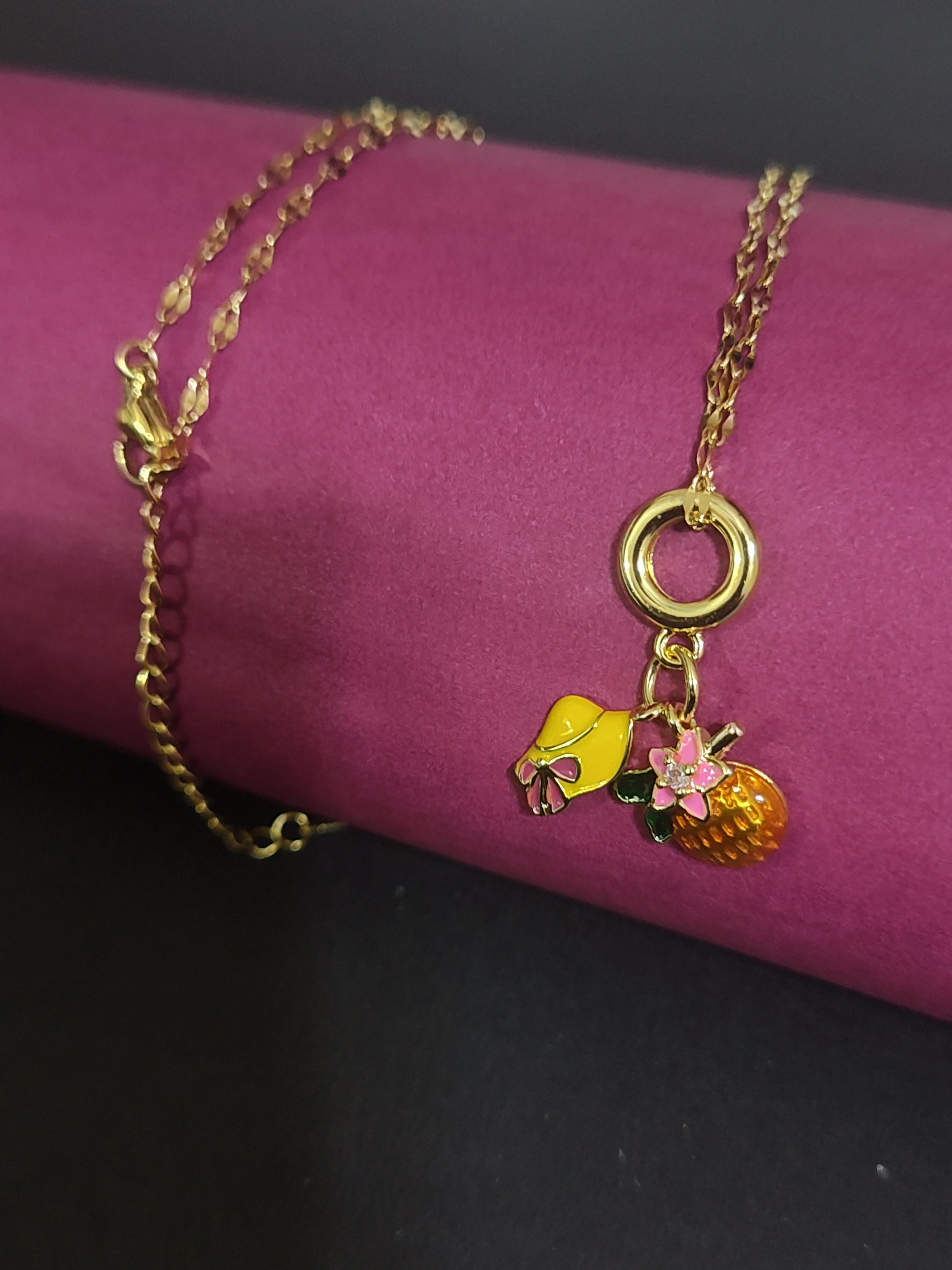 Anti-tarnish fruit and bow charm necklace with cute details.
