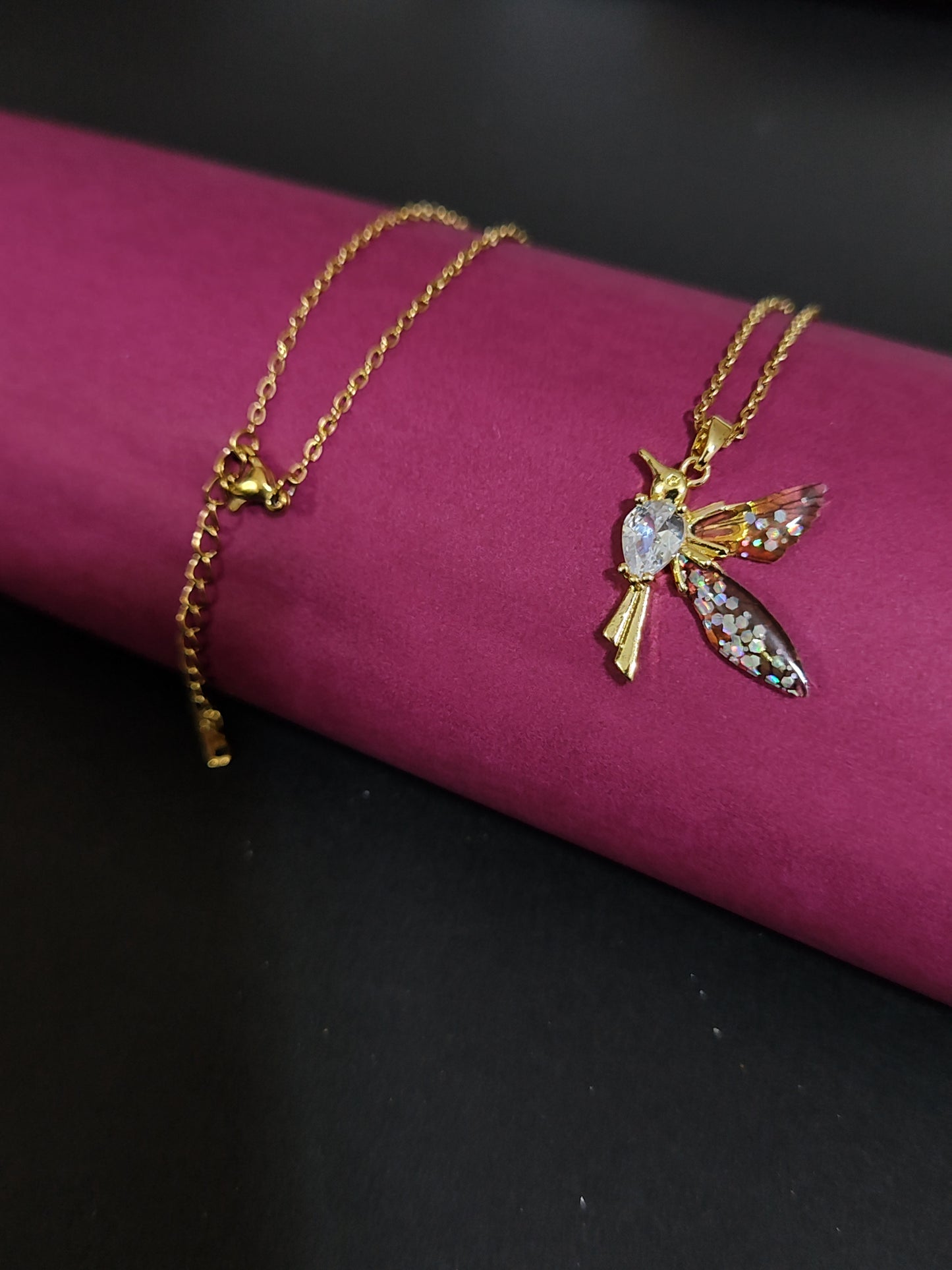 Anti-tarnish hummingbird charm necklace with colorful stone details.