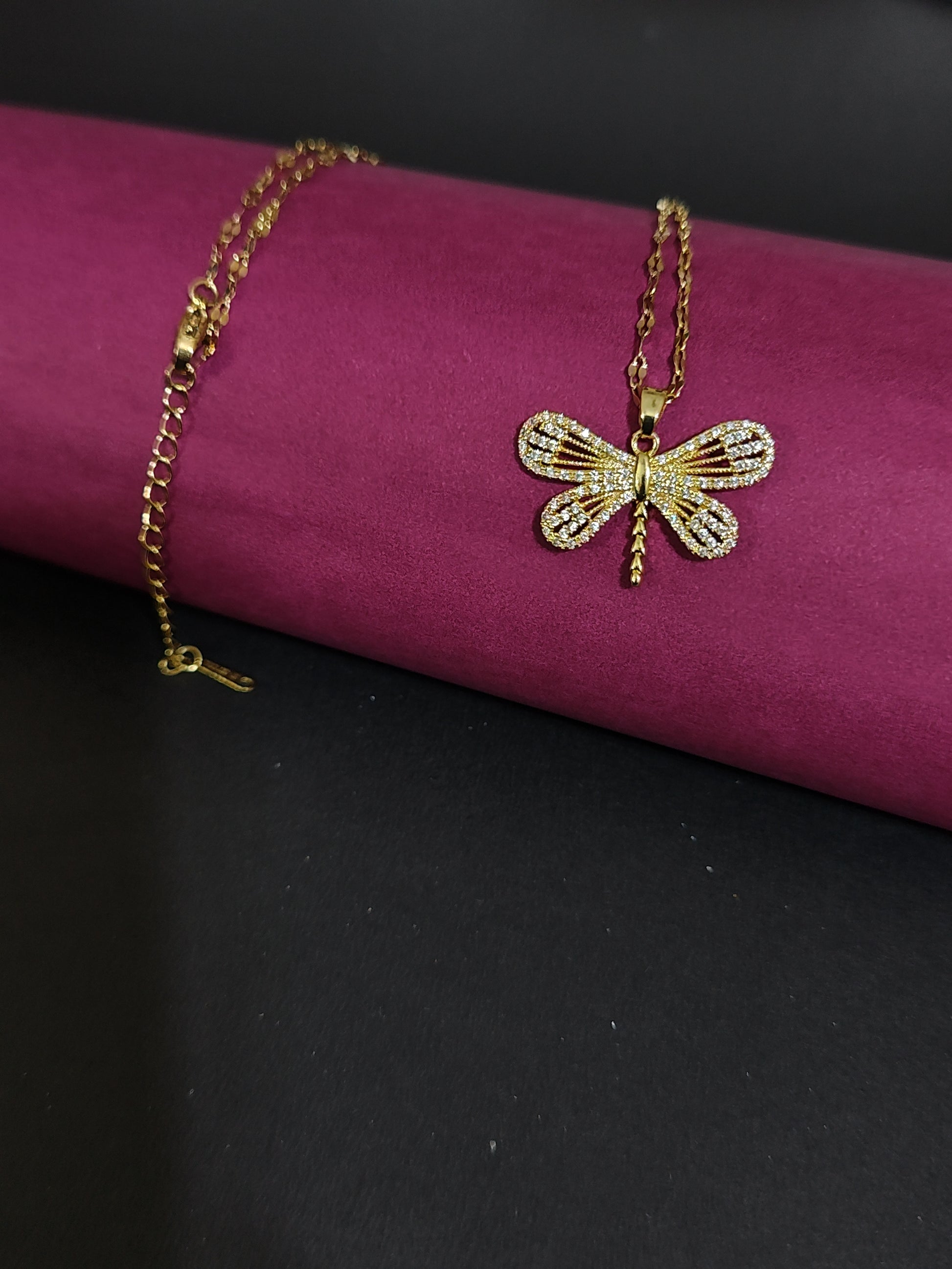 Anti-tarnish dragonfly charm necklace with rhinestone details.