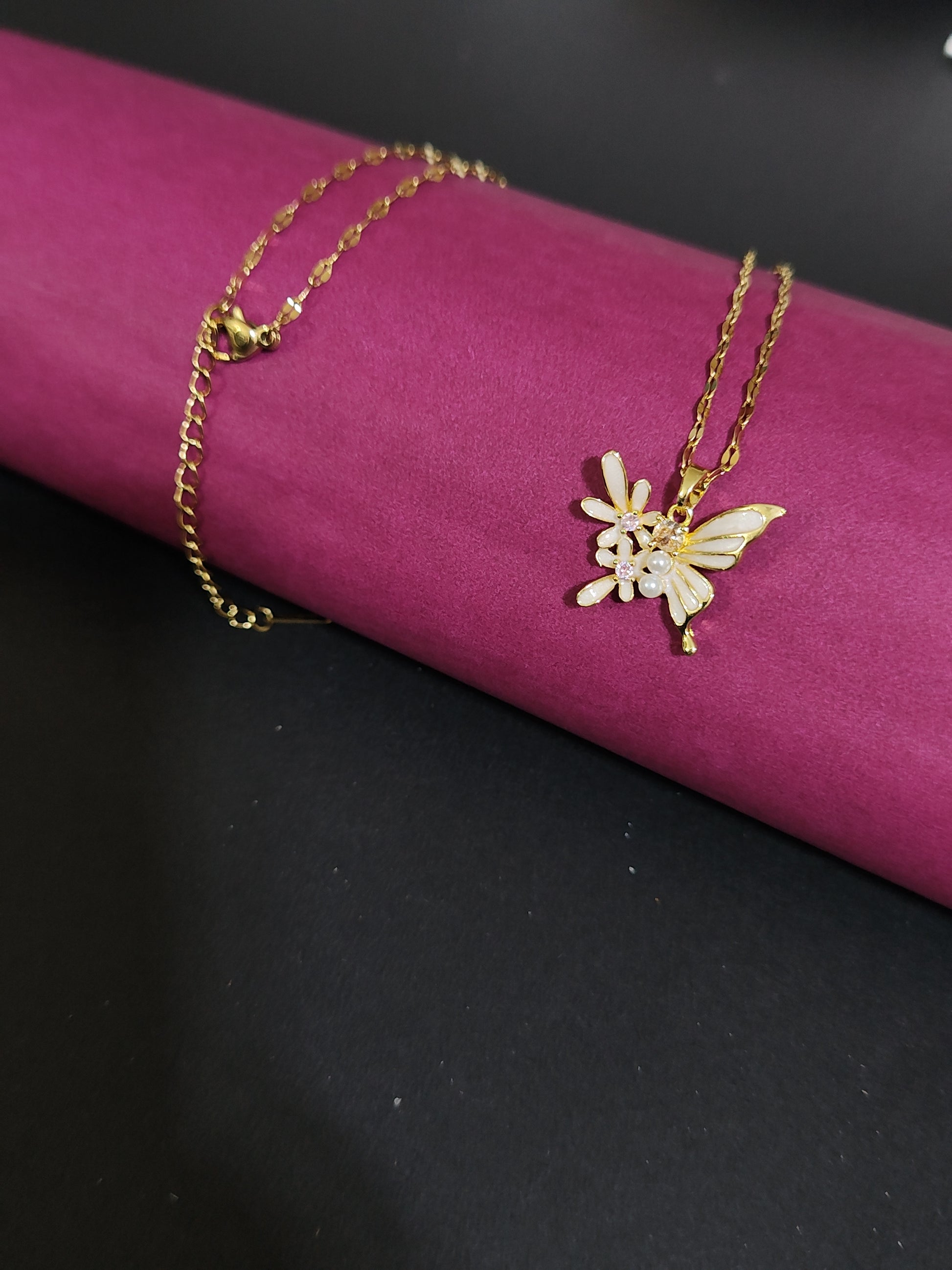 Anti-tarnish butterfly charm necklace with pearl and stone details.