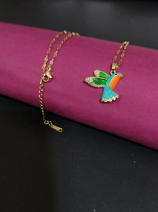 Anti-tarnish colorful bird charm necklace with rhinestone details.