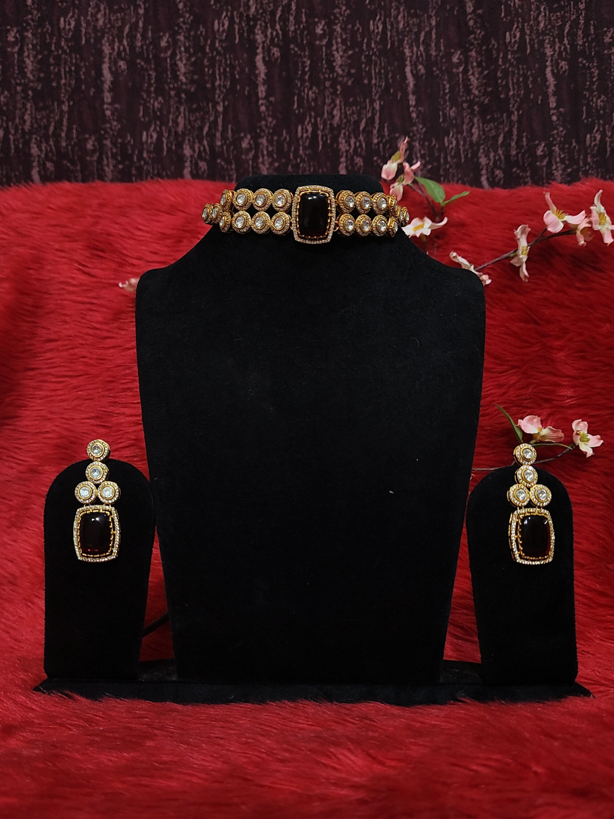 Moissanite choker necklace with ruby red stone and matching earrings on dummy