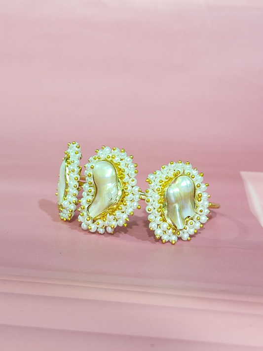 Mother of Pearl bracelet in brass with pearl beading on a pink background