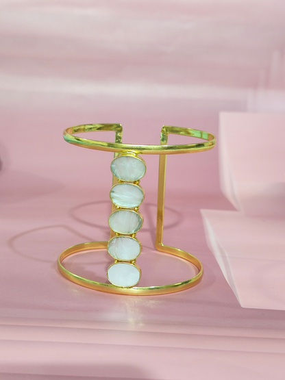 Mother of Pearl cuff bracelet in brass on pink background