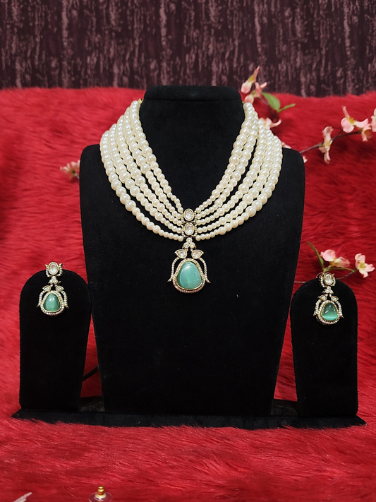Pearl choker necklace with Monalisa stone pendant and earrings on dummy
