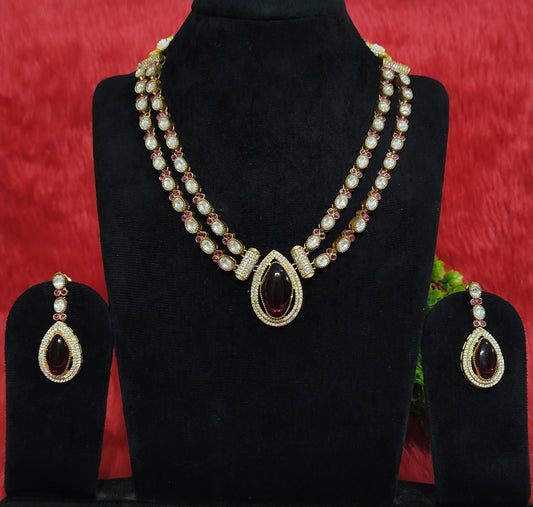 Premium kundan necklace set with twin-layer chain, maroon masonite pendant, and matching earrings displayed on black stand