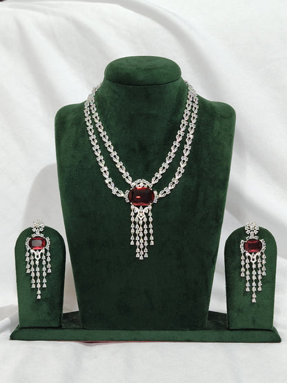 Double-layer American Diamond necklace set with red stone pendant and matching earrings in silver finish