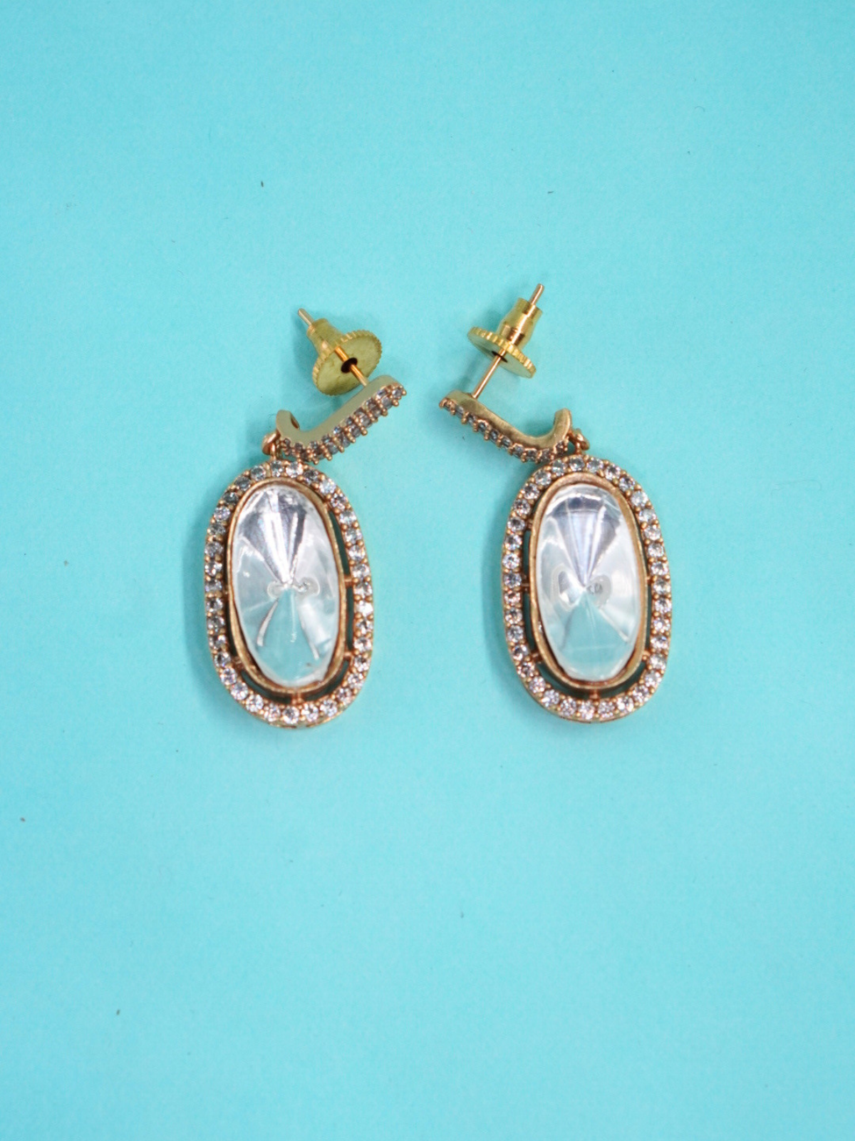 Royal Moissanite oval earrings on blue background