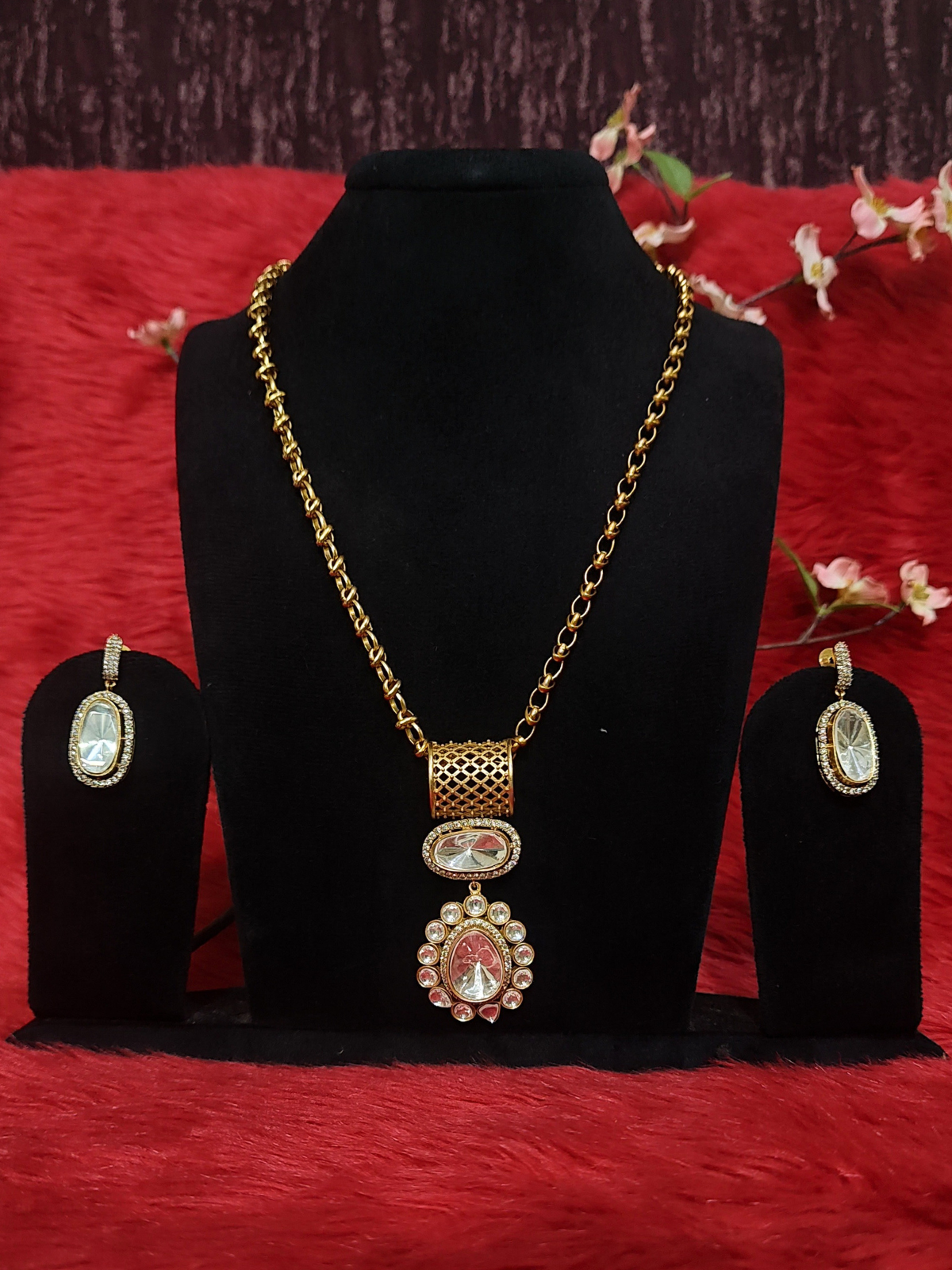 Royal Moissanite pendant necklace set with matching oval earrings on blue dummy