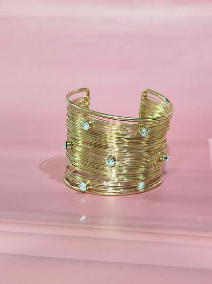 Royal anti-tarnish gold finish wide bracelet with stones on pink background