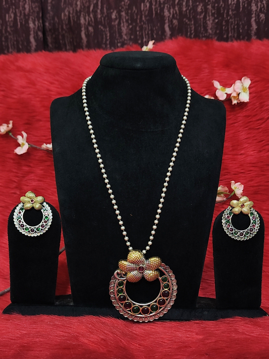 Silver replica floral pendant necklace set with white bead chain, ruby and green stones, and matching earrings