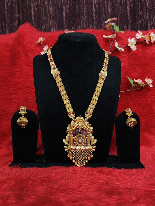 Temple-style long haram necklace set with antique pendant and jhumka earrings in copper finish on dummy