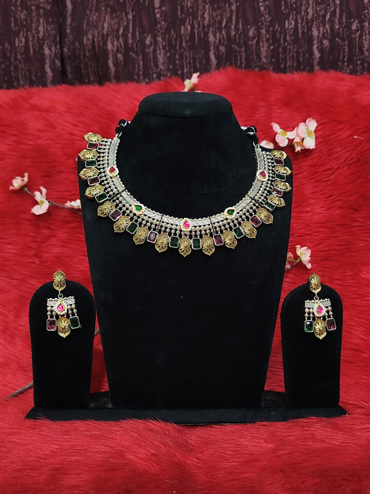 Silver replica necklace set with coin motifs and multi-coloured stones, matching earrings, displayed on black stand