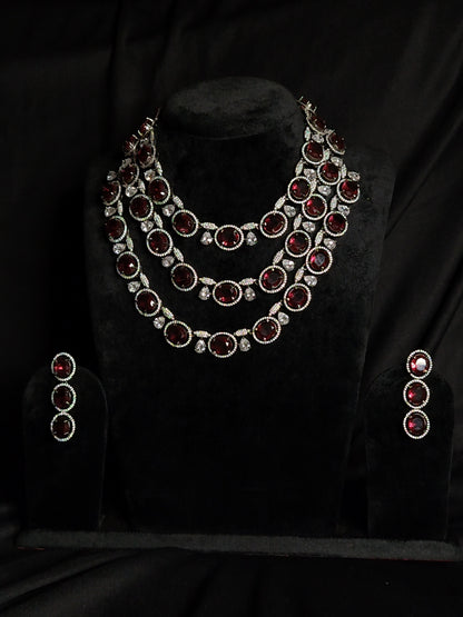 Triple-layer maroon necklace set with white American diamonds and matching earrings