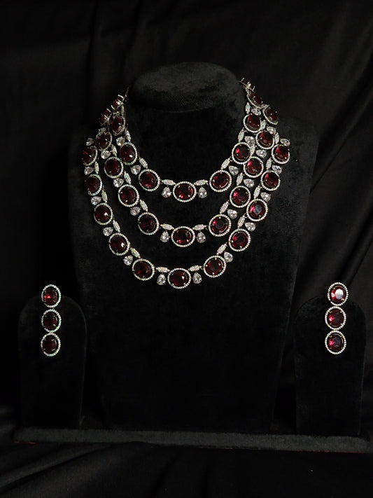 Triple-layer maroon necklace set with white American diamonds and matching earrings