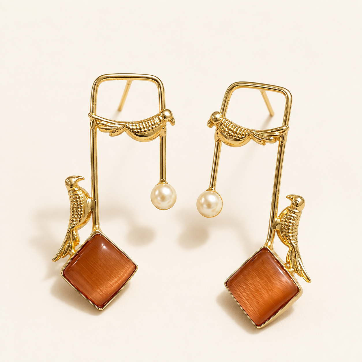 Rust Orange brass bird and artificial pearl statement earrings on ivory