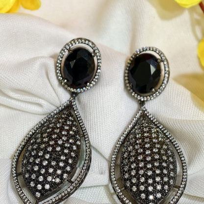 Close-up of Black Nano Setting AD Teardrop Statement Earrings