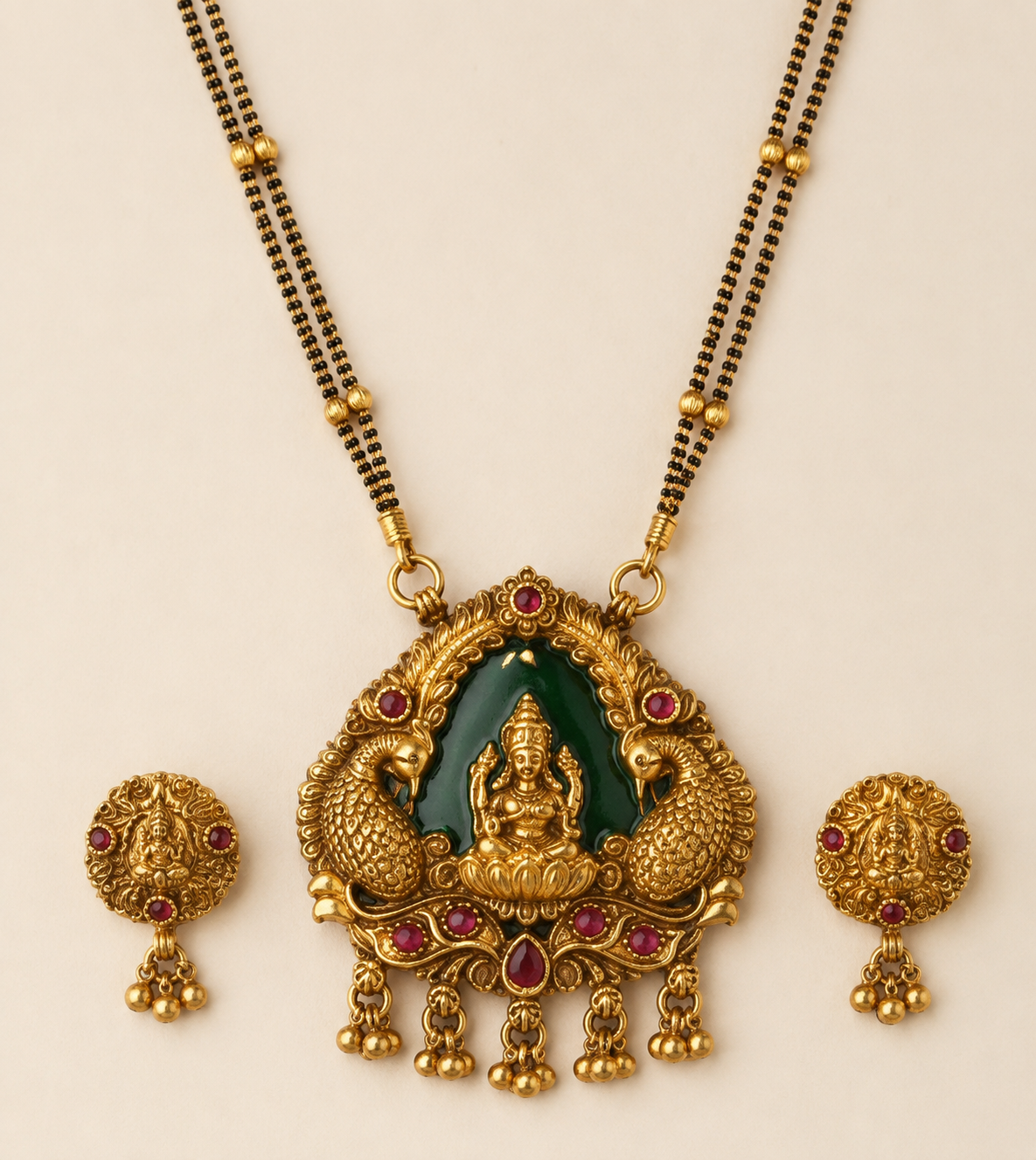 Close detail of Lakshmi peacock pendant and matching earrings