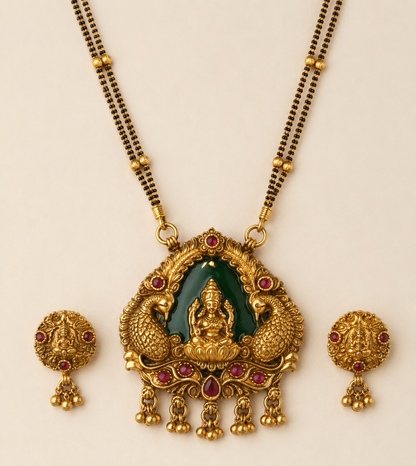 Close detail of Lakshmi peacock pendant and matching earrings